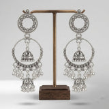 Pair of oxidized silver double hoop chandbali earrings with double jhumka on white background, clean product shot