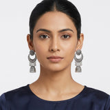 Indian model wearing oxidized silver chandbali jhumka earrings with navy blue silk top, front portrait