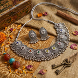 Oxidised silver-tone choker necklace with matching oval earrings on an aesthetic background
