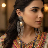 Model wearing oxidized silver chandelier earrings, side profile close-up showing full earring drape