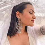 Indian model wearing oxidized silver double jhumka chandbali earrings, elegant side profile with eyes closed