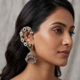 Indian model with loose dark waves wearing dual tone Navratna floral ear cuff jhumka, second angle three-quarter portrait showing the full length of the earring from ear cuff top to jhumka base with pearl ghungroo drops