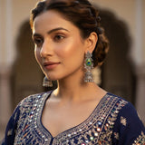 Close-up of oxidized silver peacock jhumka earring worn with teal ethnic outfit