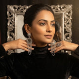 Close-up of model wearing oxidized silver mirror chandelier earring with traditional colourful mirror-work kurta