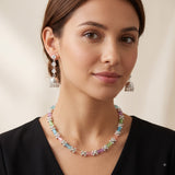 Model wearing pastel stone necklace with silver-tone jhumka earrings