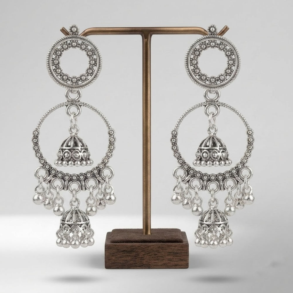 Pair of oxidized silver double hoop chandbali earrings with double jhumka on white background, clean product shot