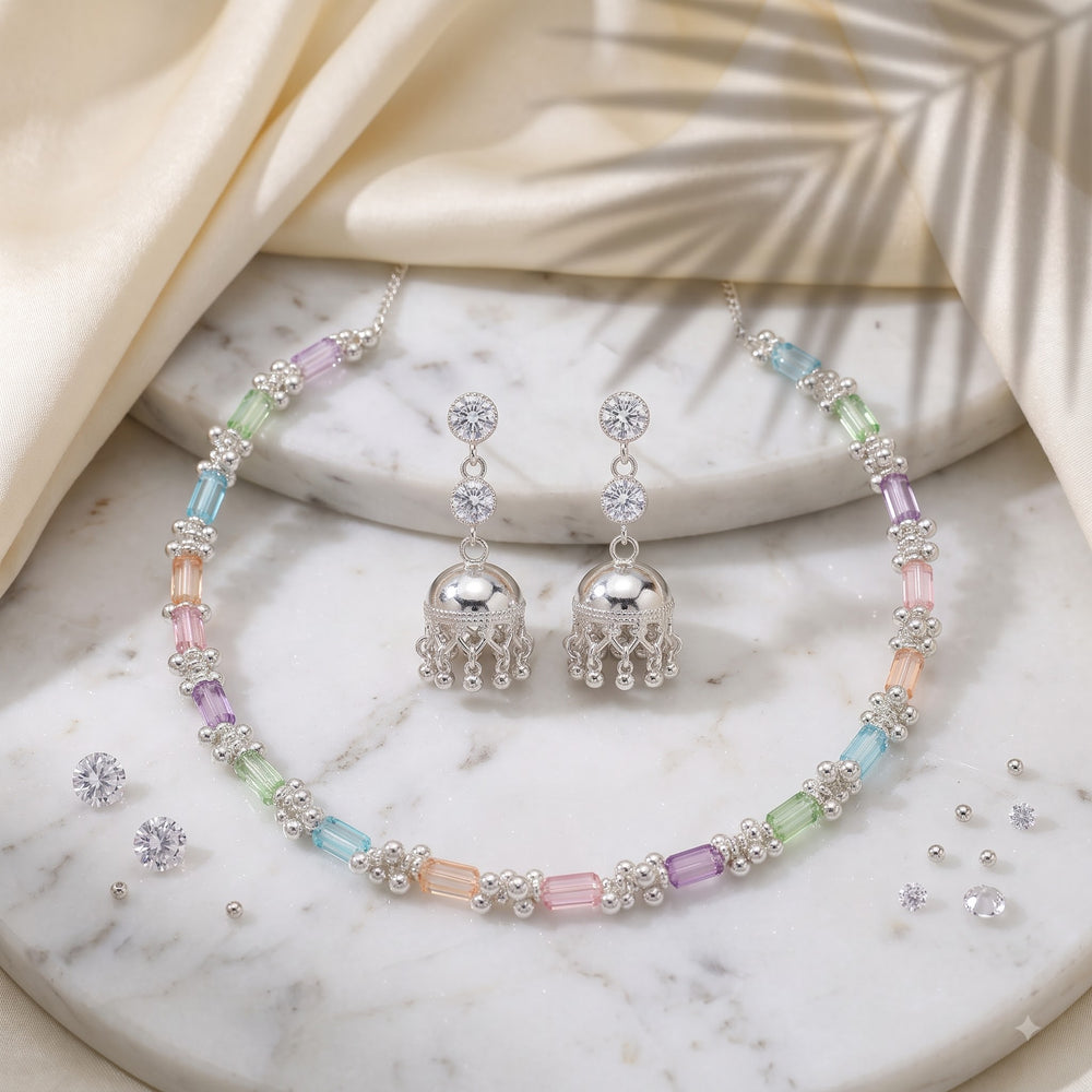 Pastel multicolour necklace and jhumka earrings set styled on a carved background