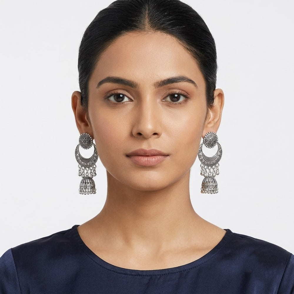 Indian model wearing oxidized silver chandbali jhumka earrings with navy blue silk top, front portrait