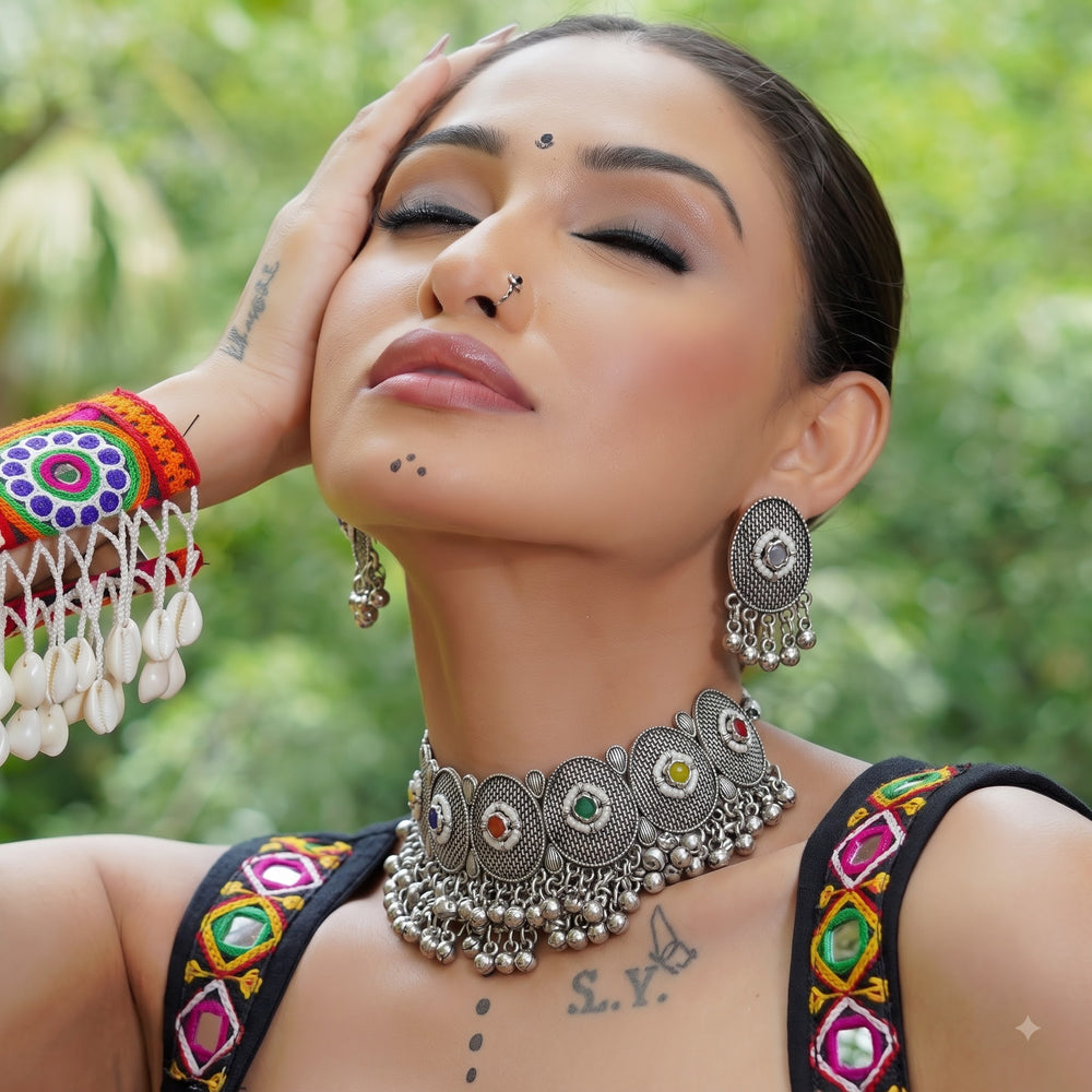 Model styling the multicolour medallion choker necklace and matching earrings with festive clothing