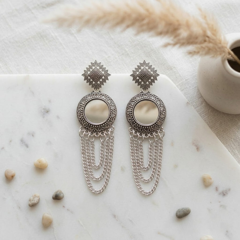 Oxidized silver chandelier earrings styled in aesthetic flat lay with antique background