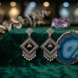 Oxidized silver diamond jhumka earrings on green velvet with agate stone aesthetic