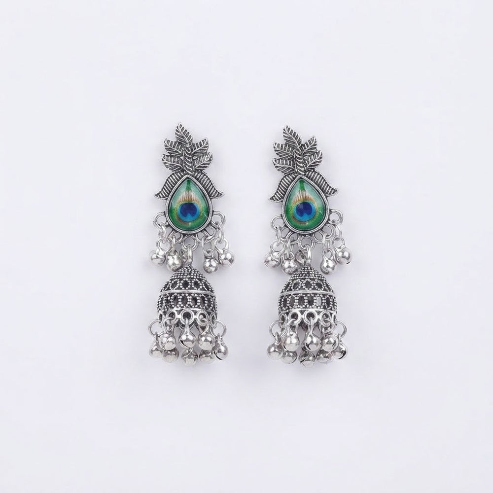 Oxidized silver peacock jhumka earrings, flat lay on white background