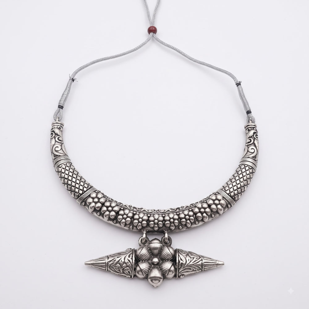 Product shot of oxidised hasli collar necklace on white background