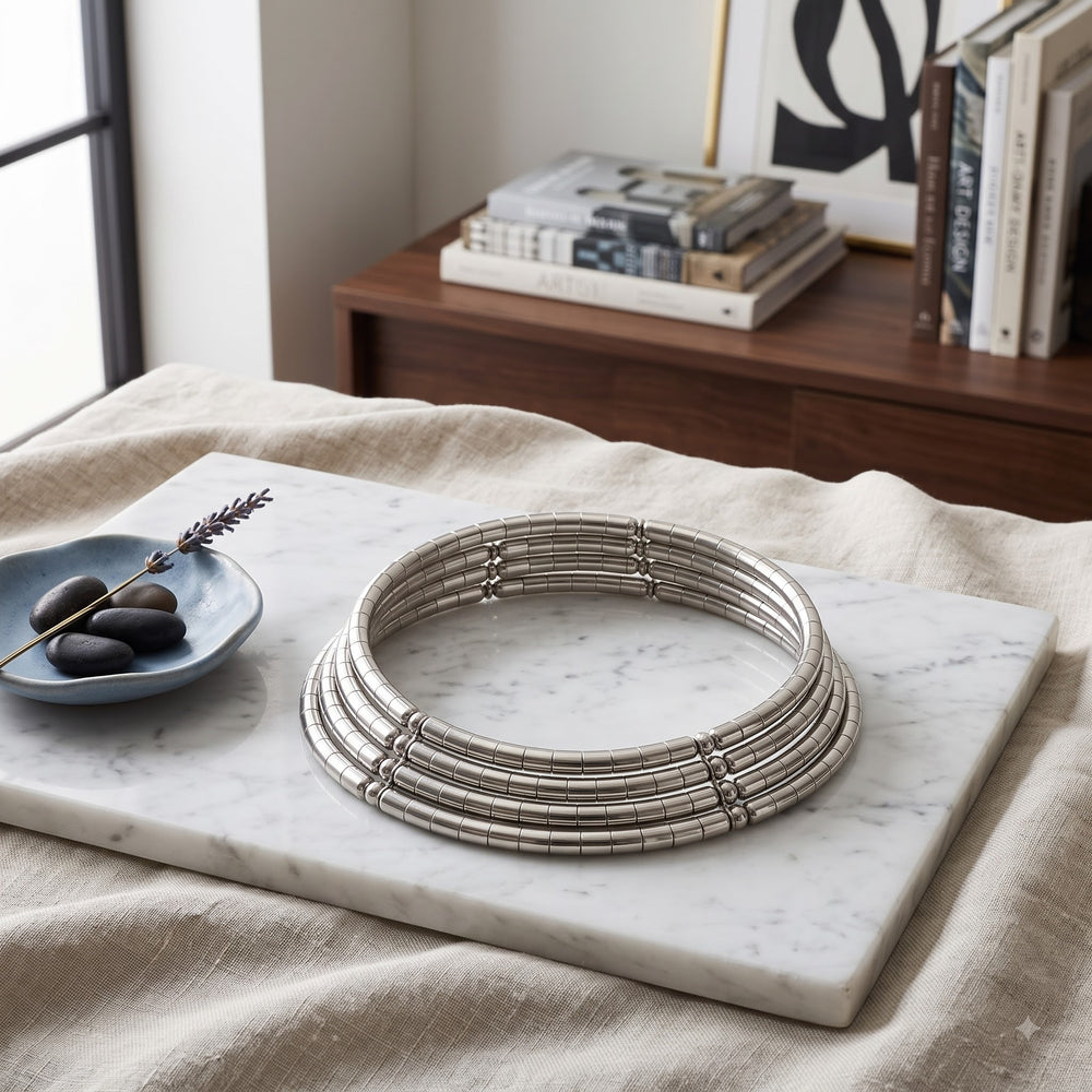 Silver-tone choker necklace styled on a marble surface