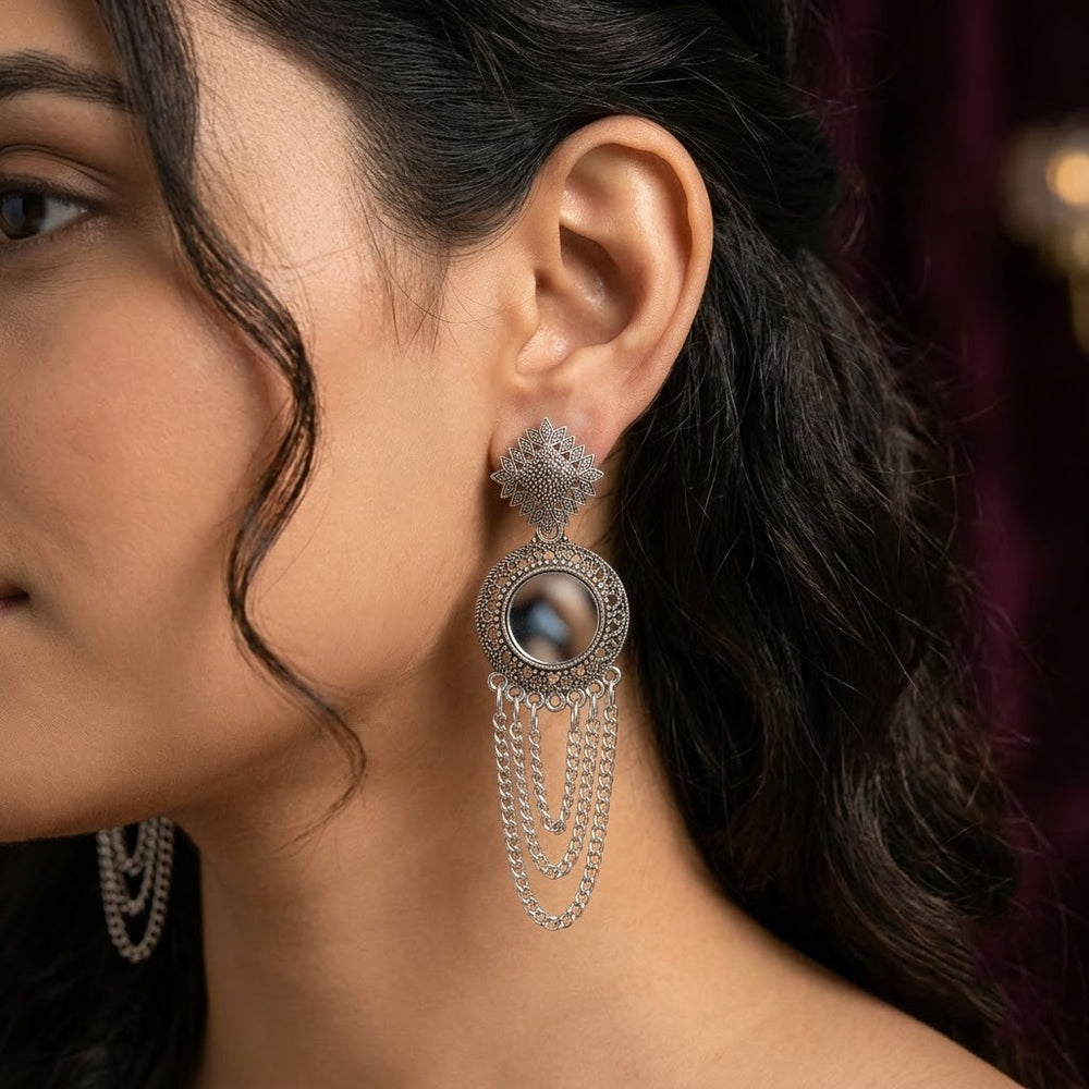 Indian model in teal silk kurta wearing oxidized silver mirror chandelier earrings, smiling portrait